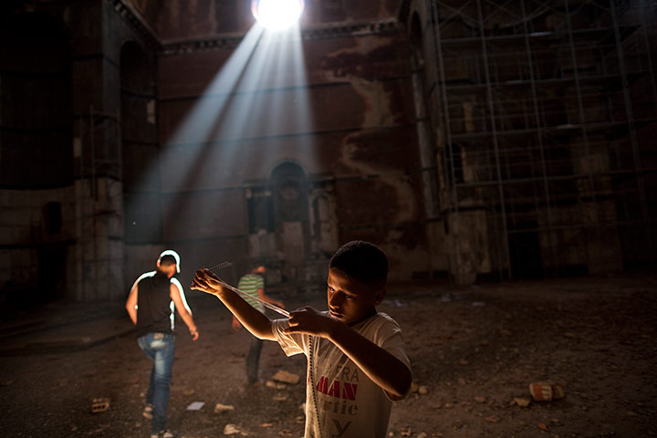 24 hours in pictures: Boy looks at a reel of film, Benghazi, Libya