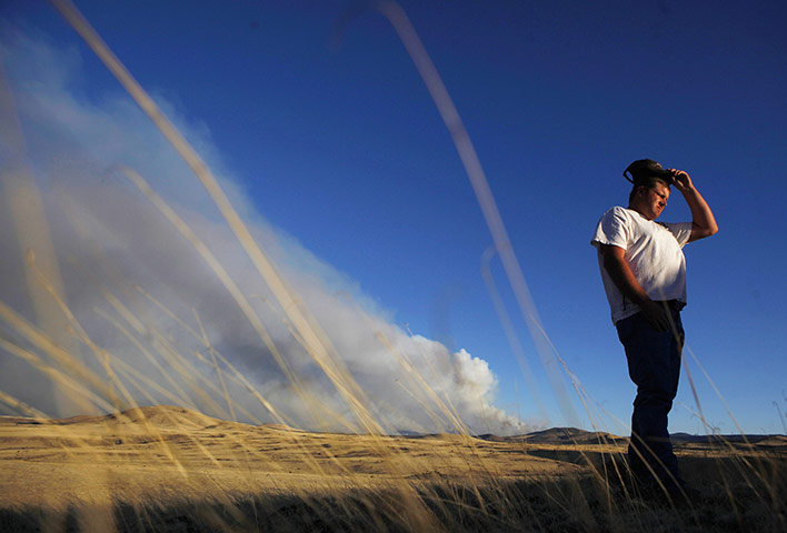 Arizona Wildfire: Jason Hill stands at the top of a hill top see the fire