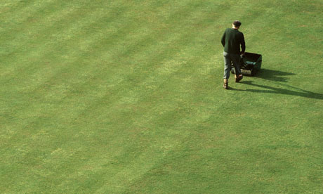 GARDENER MOWING LAWN
