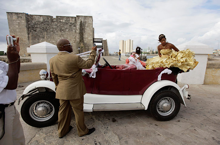 24 hours in pics: Man takes pictures of his daughter as she sits in a convertible car, Cuba