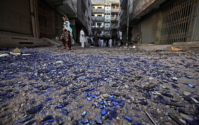 24 hours: Peshawar, Pakistan: Pieces of glass scattered at the site of an explosion 