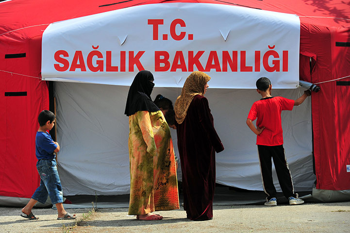 Syrian refugees: Syrian refugees wait for a medical at the Boynuyogun Red Crescent camp