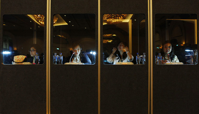 24 hours: Jakarta, Indonesia: Translators sit in their cubicles during a debate