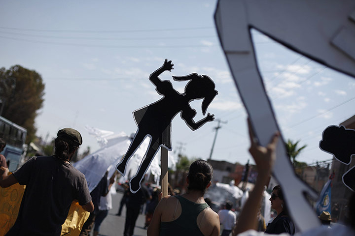 FTA: Tomas Bravo: Residents hold up cardboard figures during a march in Chihuahua 