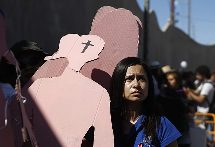 FTA: Tomas Bravo: A woman holds a cardboard figure after a rally in Ciudad Juarez