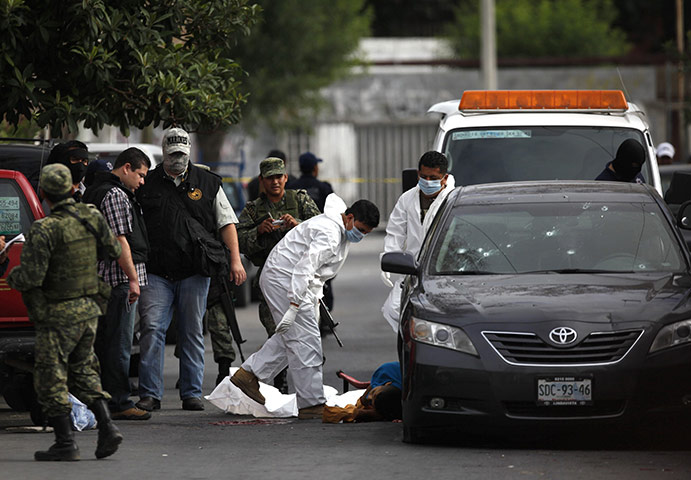FTA: Tomas Bravo: Members of a forensic team prepare to remove the slain body