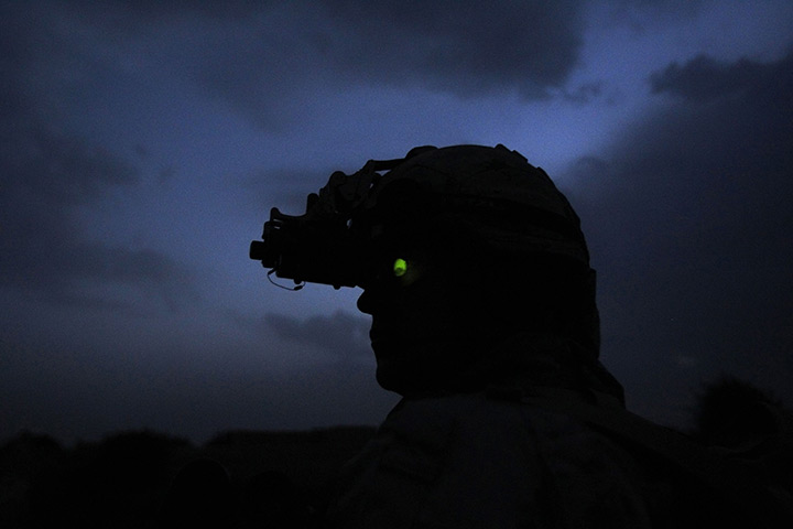 24 hours in pictures: Canadian soldier uses night vision goggles during patrol in Panjwai