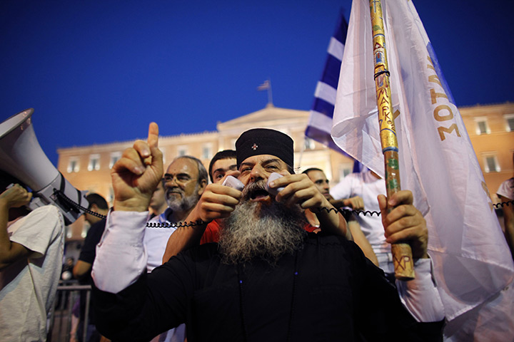 24 hours in pictures: Orthodox monk speaks to protesters in front of the Greek Parliament