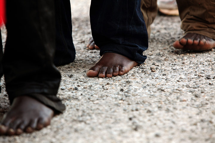 24 hours in pictures: Motril, Spain: Barefoot would-be immigrants wait to be transferred