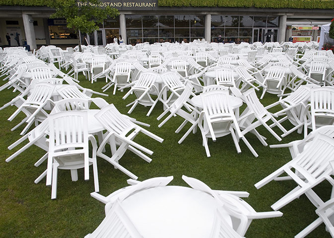 Ascot Ladies day: Empty table and chairs in the bar area as the rain falls during Ladies Day