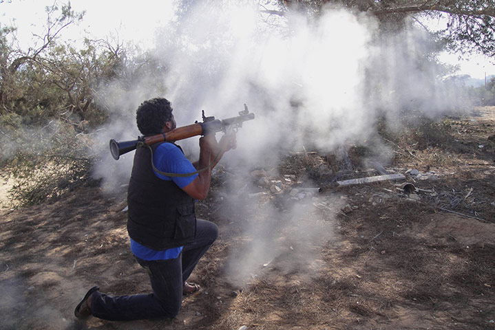 24 hours: A rebel fighter fires a rocket-propelled grenade in Libya