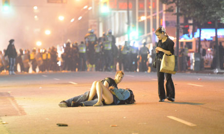 A second photograph taken by Richard Lam of the 'kissing couple' lying in a Vancouver street