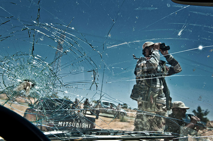 24 hours in pictures: Libyan rebels in military fatigues scan the area, Lawania, Libya