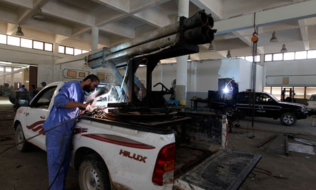 Libyan mechanics weld weaponry onto civilian pickup trucks in Misrata