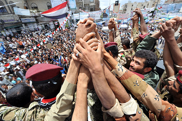 Yemen: Yemeni soldiers grasp hands as they join anti-government protesters