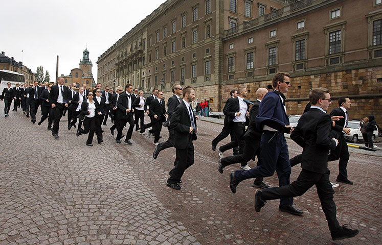 24 hours: Stockholm, Sweden: People dressed as Swedish security personnel jog