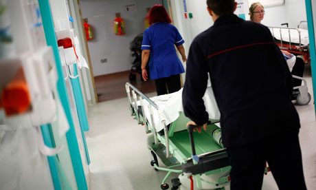 man wheeling hospital bed