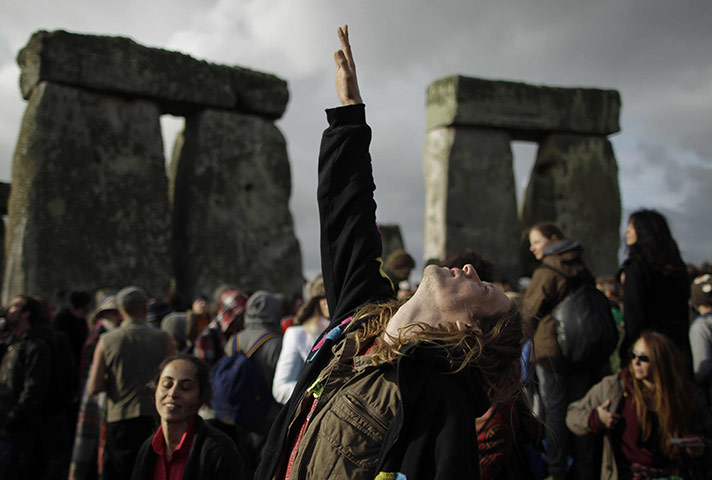 Summer solstice: A reveller reaches up to the sky during the summer solstice 