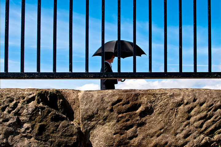 In pictures: hot: man in business suit with an umbrella