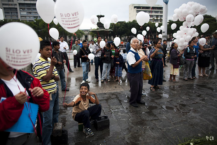 24 hours in pictures: Guatemala City, Guatemala: People hold balloons for disappeared people 