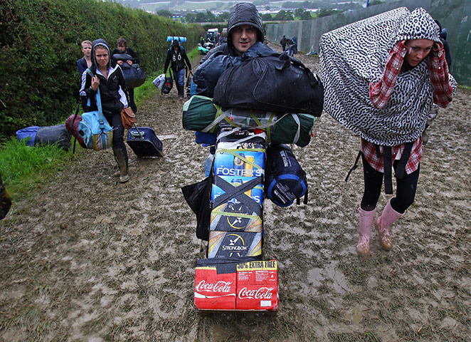 Glasontbury arrivals: Music fans arrive with provisions in the mud and the rain 