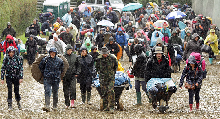 Glastonbury arrivals: Rain-hardy revellers descend on the 900-acre farm