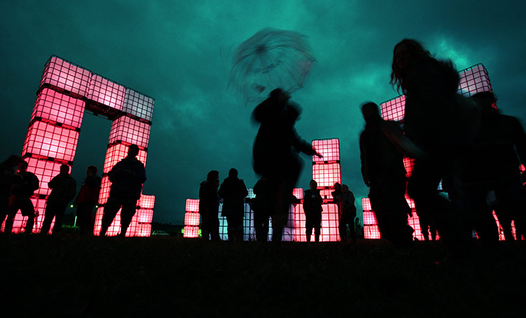 Glastonbury day 1: Festival goers gather at Cubehenge in the Dance Village area 