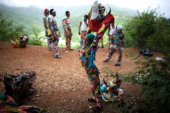 24 hours pictures: A girl dressed as a dancing devil at a traditional dance,  Venezuela