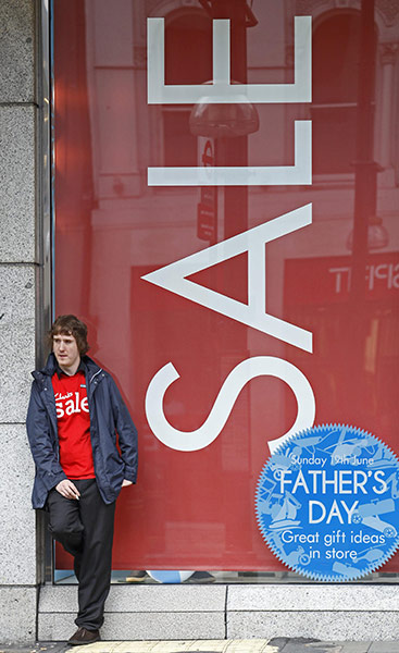 Week in Business: A man stands in front of a shop window in Oxford Street in London
