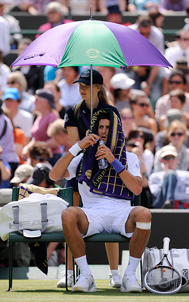 Wimbledon day 4: Novak Djokovic shelters from the sun