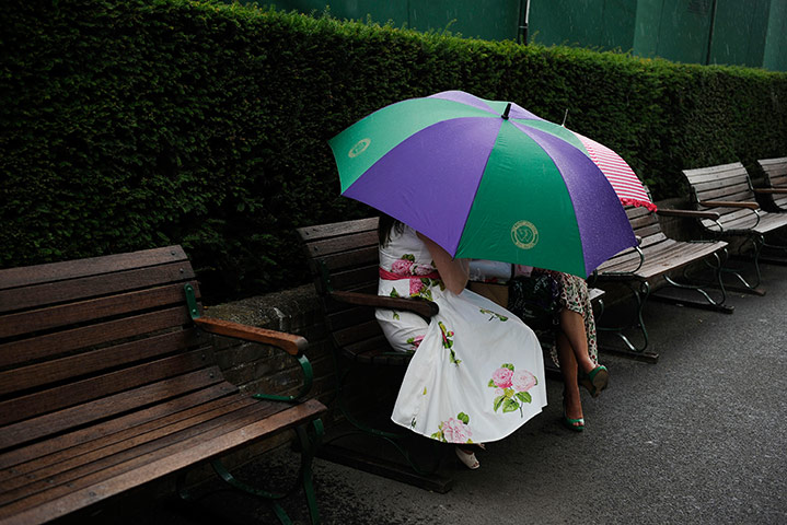 Wimbledon day 4: Wimbledon spectators under an umbrella