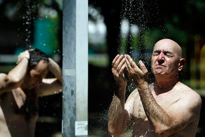 24 hours in pictures: A man takes a cold shower at the Ada Ciganlija lake in Belgrade