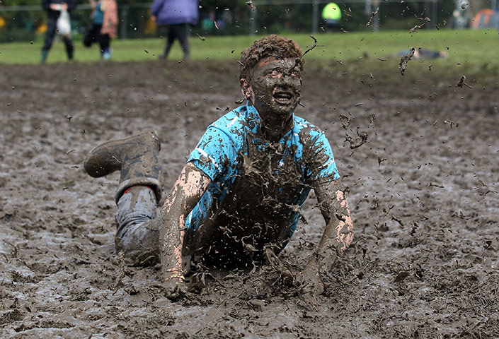 24 hours in pictures: Man dives in the mud at the Glastonbury Festival site at Worthy Farm