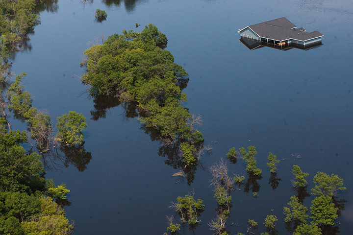 24 hours in pictures: A home is nearly submerged by flood waters from the Souris River