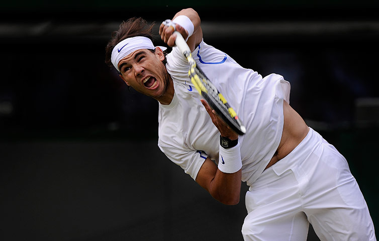 Wimbledon day 6: Rafa Nadal fires a serve to Gilles Müller