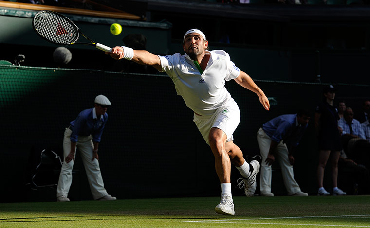 Wimbledon day 6: Marcos Baghdatis stretches to reach a Novak Djokovic serve