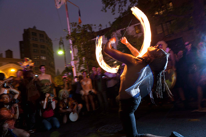 24 Hours: New York, USA: A man fire spins for the crowds 
