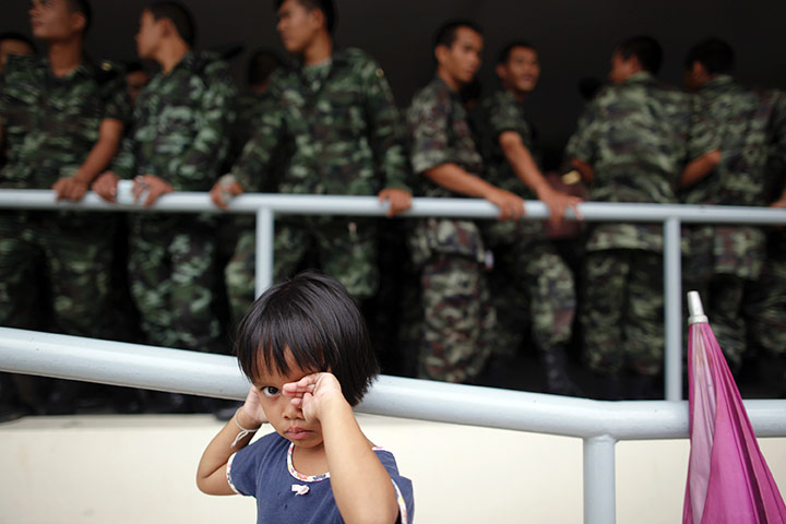 24 Hours: Udon Thani, Thailand: A girl waits outside a polling station