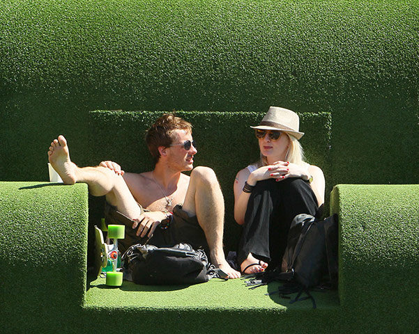 Hot Weather: People sit on a giant grass chair at the National Theatre
