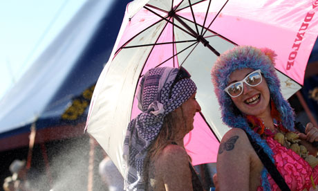 Festival-goers shelter from the sun at Glastonbury