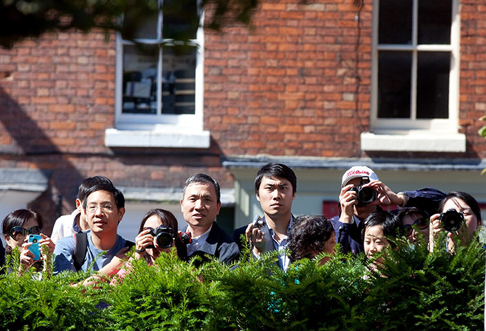 Wen Jiabao in UK: Supporters of Chinese Premier Wen Jiabao look on and take photos