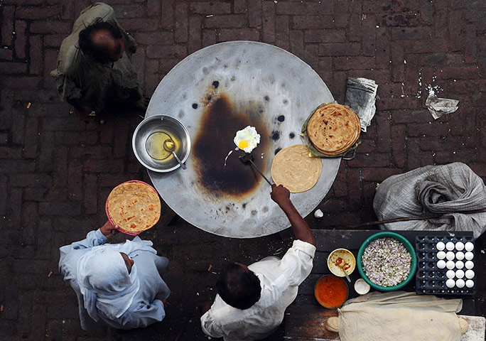 24 hours in pictures: a roadside cook prepares breakfast for customers in Lahore