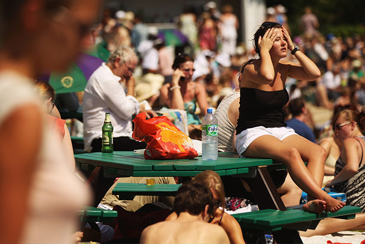 Hot Weather: Tennis spectators lay in the sun