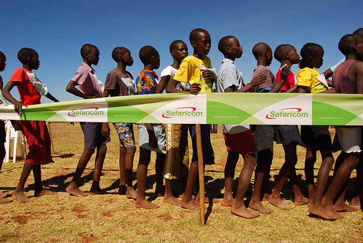 Running with Kenyans: Barefoot children in the finishing funnel at a cross-country race