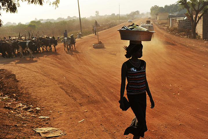 Southern Sudan: A pedestrian walks on an unpaved road iin Juba