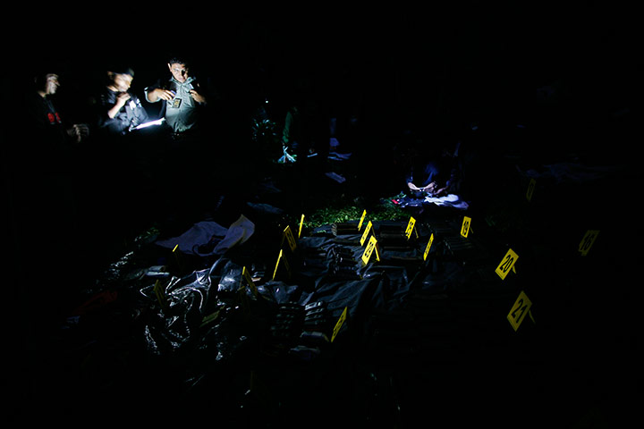 24 hours in pictures: Police investigators work at the site after a raidm Guatemala