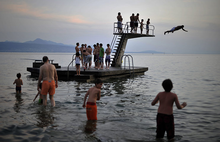24 hours in pictures: A youth jumps into Lake Geneva