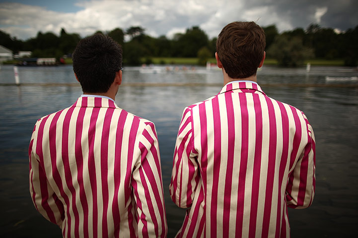 Henley Royal Regatta: Rowing club members watch Henley Royal Regatta from the river bank 