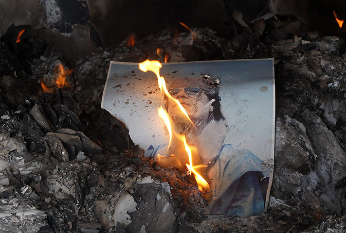 FB 17: People burn pictures of Libyan leader Gaddafi