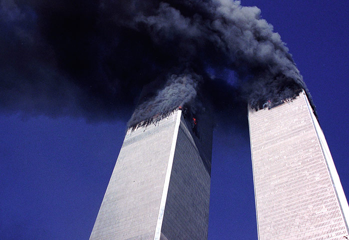 Seven Days: Both Twin Towers burn and exhaust large plumes of smoke
